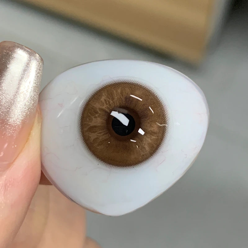 Real-life view of the soft, rich brown tint on fingertip, showing the authentic quality of this elite collection.