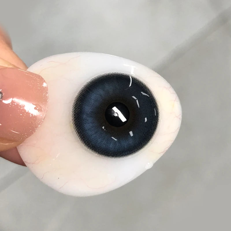 Authentic view of this vibrant blue tint on fingertip, highlighting the soft texture and high-pigment shimmer quality.