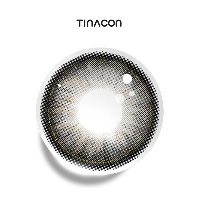 Milky Way Gray colored contact lenses exhibiting a bold charcoal rim that transitions into a shimmering silver iris with dynamic, starburst-like lines.