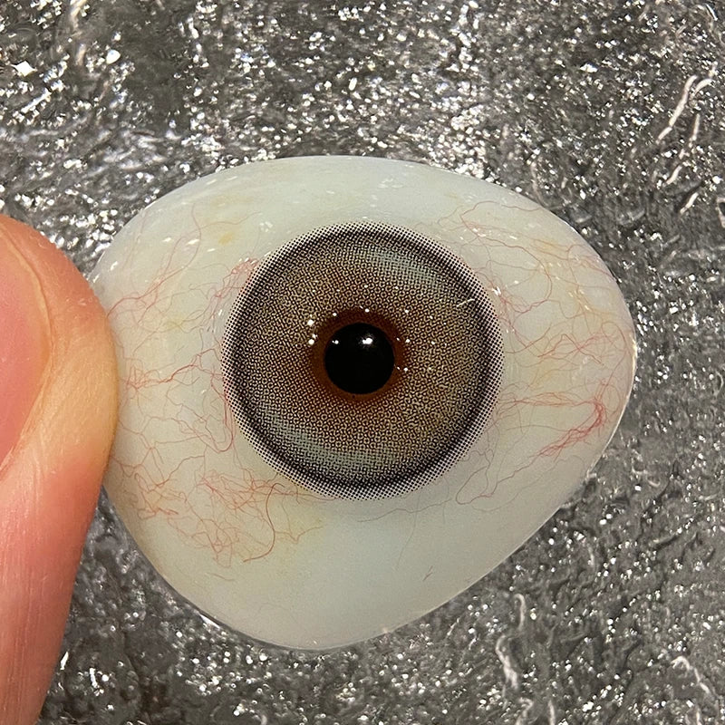 Witnessing the unique tint on a fingertip to show the premium quality of these colored contacts.