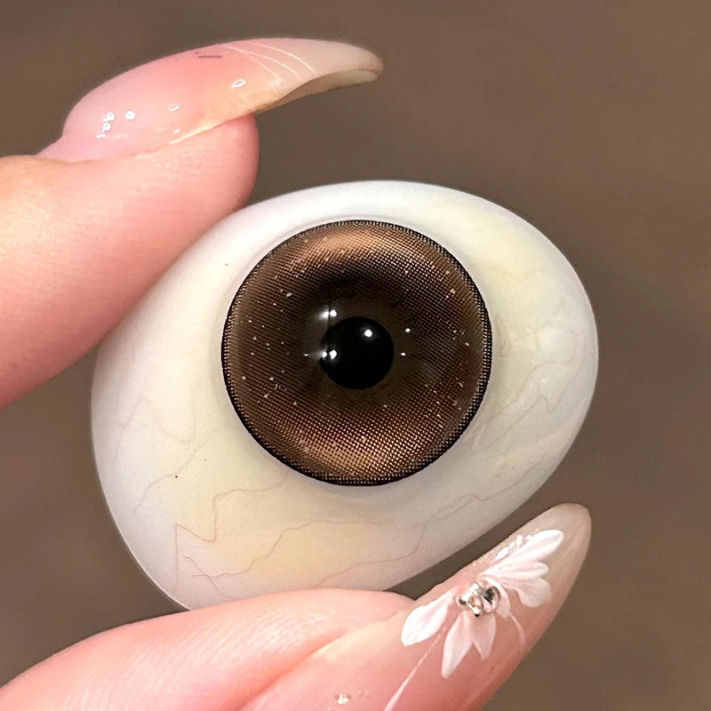 Witnessing the sheer, glowing warmth of these colored contacts on a fingertip, highlighting the quality of these colored contacts.