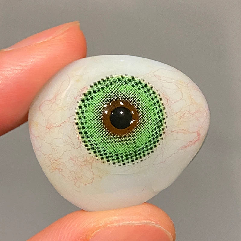 Checking the vibrant, leafy-green pigment on a fingertip to ensure superior color payoff.