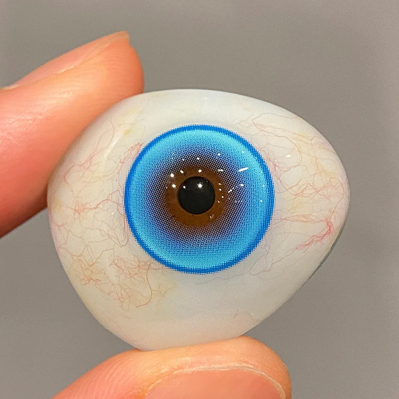 Viewing the intense, jewel-toned tint on a fingertip to confirm the superior pigment of the colored contacts.