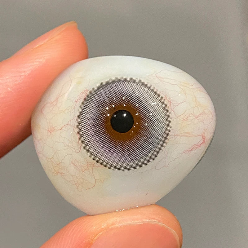 Witnessing the translucent opulence of this soft blue tint on a fingertip, highlighting the collection's authentic quality.