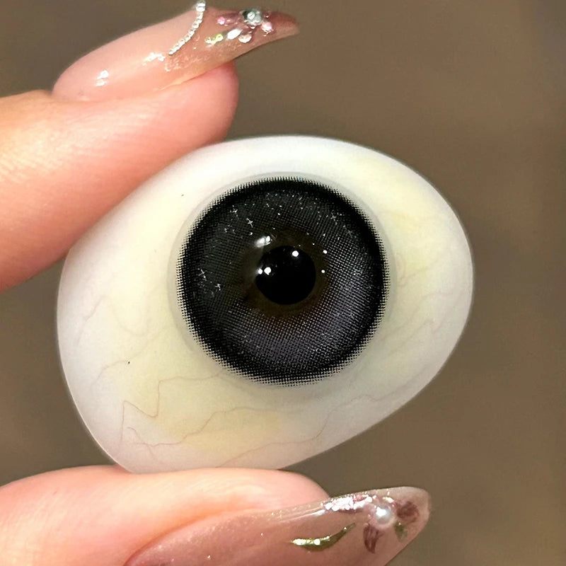 Viewing the light purple and dark pigment on a fingertip to show the premium quality of Moonchild Purple colored contacts.
