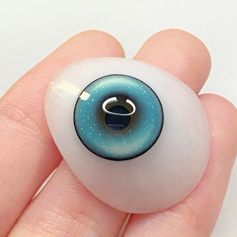 Witnessing the vivid ocean tint on a fingertip, highlighting the soft material of these colored contacts.